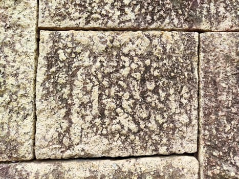 Close-up view of weathered stone blocks showcasing intricate textures, patterns, and blank areas suitable for overlaying text or graphics.