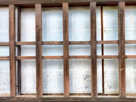 A wooden lattice frame showcases a textured background, offering a clean area for text and design elements while maintaining natural aesthetics.