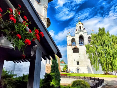Yaroslavl, Russia - July 05, 2024: Colorful flowers frame the view of the Kremlin in Yaroslavl, highlighting its unique architecture against the clear sky.