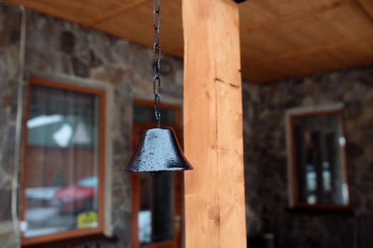 old bell on the facade of the house. The exterior of the building and design details are vintage