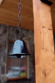 old bell on the facade of the house. The exterior of the building and design details are vintage