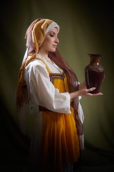 The girl, adorned in stylized eastern national clothing, holds a beautifully crafted vase, capturing the essence of Rebekah from biblical stories.