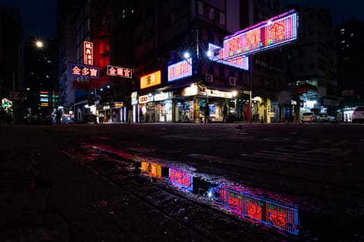 HONG KONG, CHINA - SEPTEMBER 28, 2024: Busy street corner at night with famous old neon signage in Portland St, Mongkok on Kowloon in Hong Kong