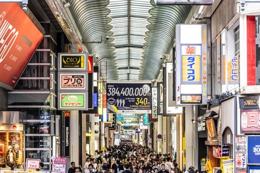 OSAKA, JAPAN - SEPTEMBER 24 2024: The view inside of the long covered and crowded shopping street, Shin Sai Bashi Suji in Dotonbori, Osaka, Japan