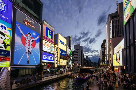 OSAKA, JAPAN - SEPTEMBER 24 2024: The view down Dotonbori River from Ebisubashi Bridge on a clear autumn day in Osaka, Japan