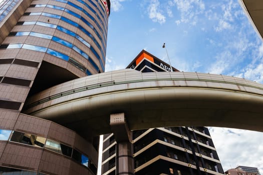 OSAKA, JAPAN - SEPTEMBER 25 2024: The famous 'highway thru a building'. The off ramp for the Umeda Exit of the Ikeda Route of the Hanshin Expressway going thru the Gate Tower Building in Downtown Osaka, Japan