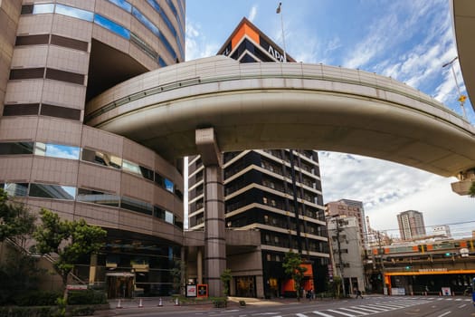 OSAKA, JAPAN - SEPTEMBER 25 2024: The famous 'highway thru a building'. The off ramp for the Umeda Exit of the Ikeda Route of the Hanshin Expressway going thru the Gate Tower Building in Downtown Osaka, Japan