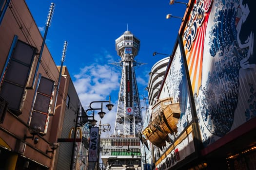 OSAKA, JAPAN - SEPTEMBER 26 2024: The famous Shinsekai area with Tsutenkaku Tower on a clear autumn day in Osaka, Japan