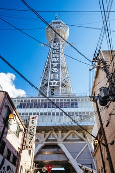 OSAKA, JAPAN - SEPTEMBER 26 2024: The famous Shinsekai area with Tsutenkaku Tower on a clear autumn day in Osaka, Japan
