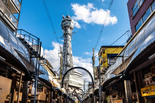 OSAKA, JAPAN - SEPTEMBER 26 2024: The famous Shinsekai area with Tsutenkaku Tower on a clear autumn day in Osaka, Japan