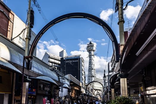 OSAKA, JAPAN - SEPTEMBER 26 2024: The famous Shinsekai area with Tsutenkaku Tower on a clear autumn day in Osaka, Japan