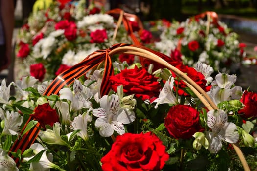 Basket with red rose and lily flowers Saint George ribbon