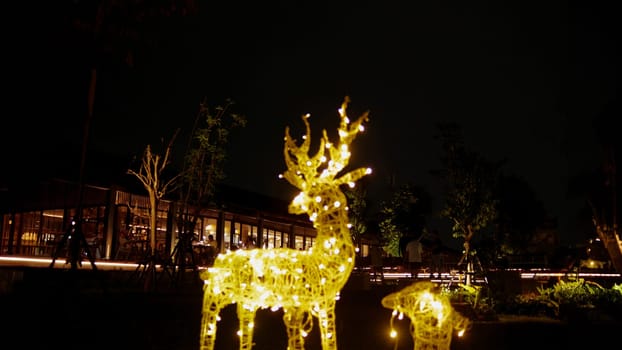 Illuminated reindeer Christmas decoration at night in the cafe