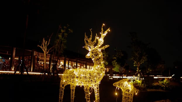 Illuminated reindeer Christmas lights decoration at night in the cafe