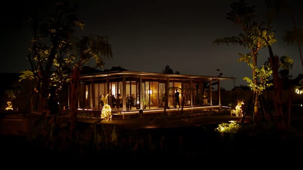 Modern house with illuminated interior at twilight surrounded by trees in the dark night