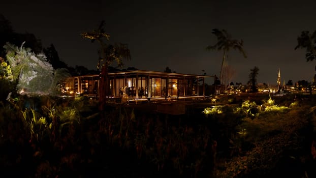 Serene night landscape with illuminated wooden cabin and glowing plants, creating a magical atmosphere in the dark night