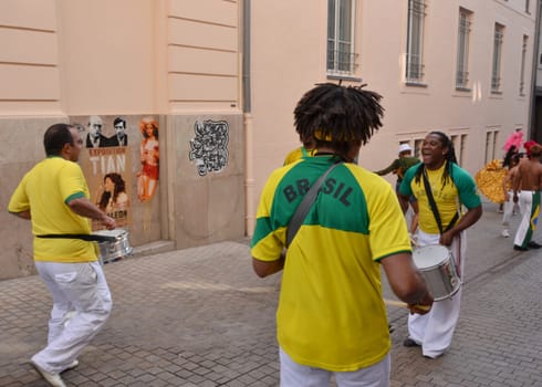 LE MANS, FRANCE - JUNE 13, 2014: Brazilian man dancing at a parade of pilots racing in Le mans,France.