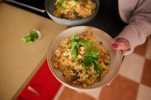 A vibrant bowl of vegetable paella featuring rice, vegetables, and garnished with parsley served fresh.