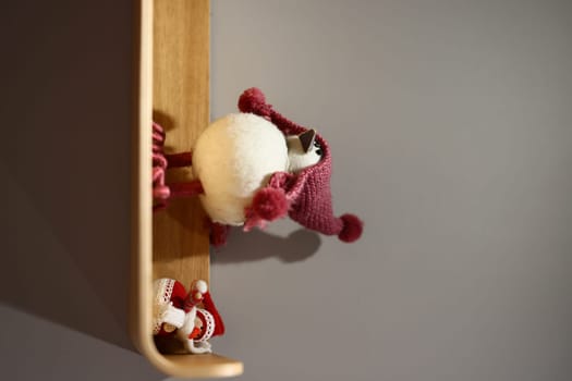 Charming and whimsical holiday decorations adorned with cute characters displayed on a beautifully crafted wooden shelf