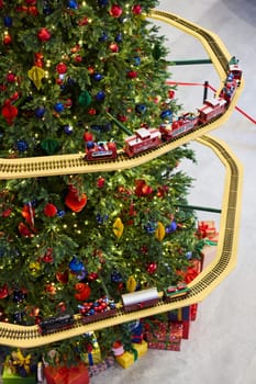 A festive Christmas tree with colorful ornaments and a charming model train, creating a joyful holiday scene