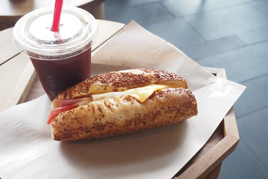 A delicious and tasty sandwich paired with a refreshing beverage on a casual dining table