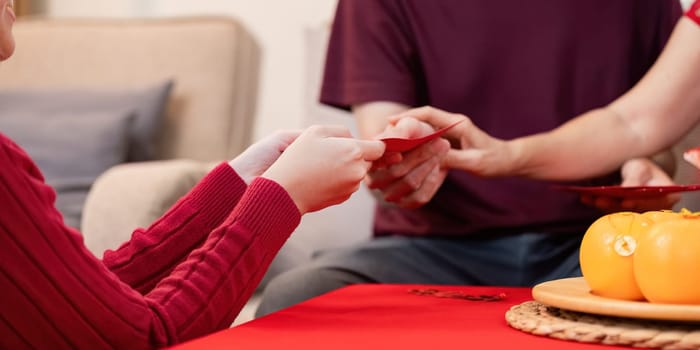 A family shares joyful traditions during Chinese New Year highlighting bonds between grandparents and their granddaughter.