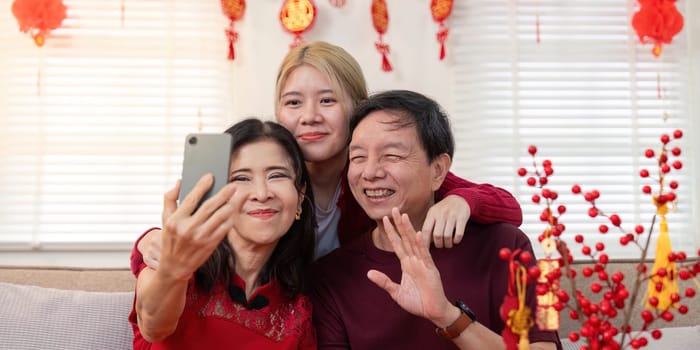 A heartfelt family reunion showcasing the joy of Chinese New Year through a granddaughter's selfie with her grandparents.
