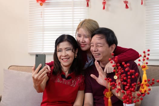 A warm family moment during Chinese New Year with grandparents and granddaughter capturing smiles and love.