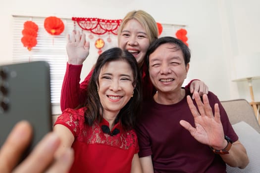 A joyful family gathers to celebrate Chinese New Year capturing cherished moments with smiles and traditions.