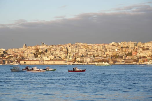 The fishing boats are elegantly and gracefully positioned against the breathtaking Istanbul skyline