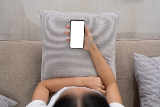 Closed up with Asian woman feels relax using smartphone in living room, Blank screen of smartphone.