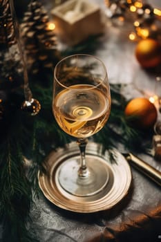 High angle of christmas table with glass of cocktail with champagne, blurred christmas tree on background. AI Generated