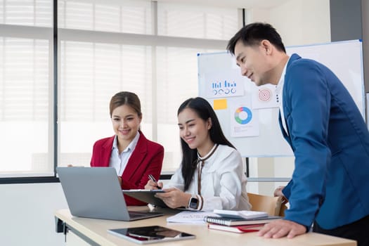 Business People Meeting using laptop computer,calculator,notebook,stock market chart paper for analysis Plans to improve quality next month. Conference Discussion Corporate Concept..