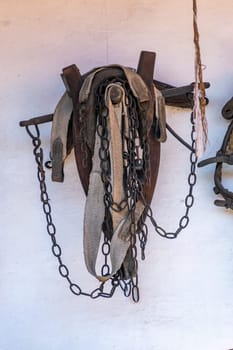 Historical harnesses for cattle hanging on the wall, as an example of old crafts and village life