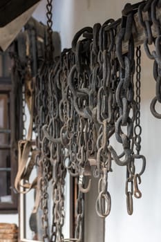 Steel chains hung on the wall for working with horses, demonstration of old procedures at work