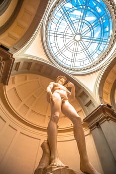 Florence, Tuscany, Italy July 18 2018: The Statue of David, completed by Michelangelo Buonarroti in 1504, is one of the most renowned works of the Renaissance, and most famous sculpture in the world. Original statue situated in Florence Accademia in Italy