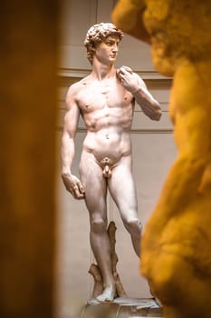 Florence, Tuscany, Italy July 18 2018: The Statue of David, completed by Michelangelo Buonarroti in 1504, is one of the most renowned works of the Renaissance, and most famous sculpture in the world. Original statue situated in Florence Accademia in Italy