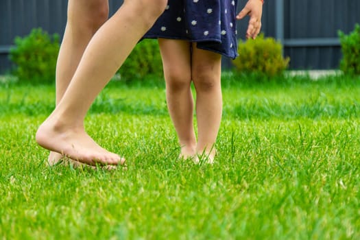 Child feet on the grass. Selective focus. Kid,