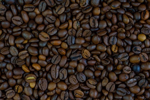 High-resolution close-up view of roasted coffee beans in various shades of brown, showcasing texture and rich detail, ideal for backgrounds or coffee-themed concepts.