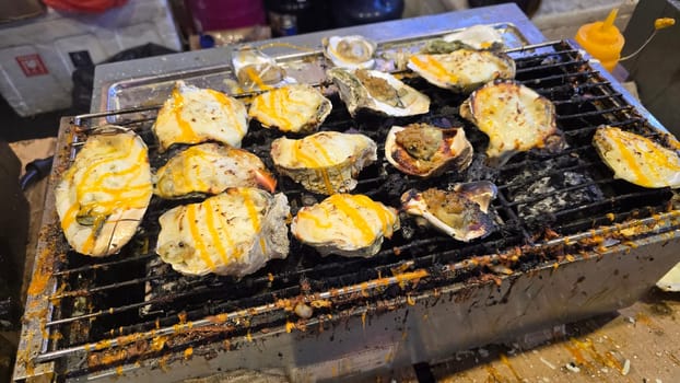 street vendor uses a torch flame to prepare delicious grilled oyster with flair and skill, showcasing the vibrant atmosphere of bustling night Thai markets. Good for recipe book