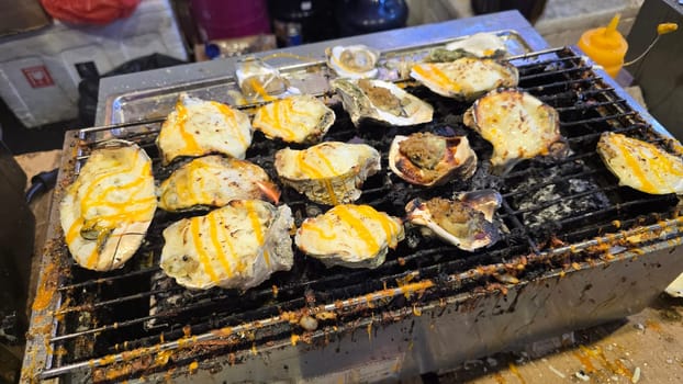 street vendor uses a torch flame to prepare delicious grilled oyster with flair and skill, showcasing the vibrant atmosphere of bustling night Thai markets. Good for recipe book