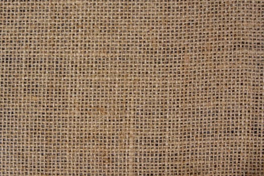 Close-up view of a burlap fabric showing its woven texture and rustic look, ideal as a natural background or material design element.