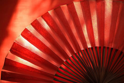 Chinese new year festival decorations with red Chinese folded fans on red background. Happy Chinese new year background concept.