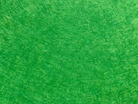 Close up of vivid green textured surface with circular patterns.