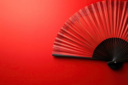 Red chinese fan without patterns close up on red background
