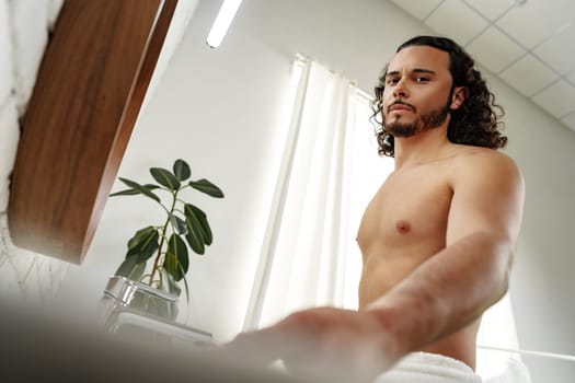 A man prepares for the day in a bright bathroom close up