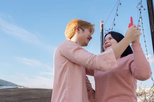 A joyful couple celebrates Valentine Day in a beautiful outdoor setting embracing love and connection.