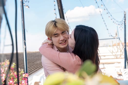 A couple enjoys a sweet moment on a rooftop celebrating love amidst stunning surroundings creating lasting memories.