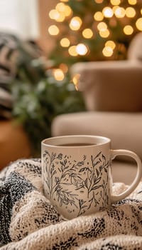 A glossy white mug adorned with a hand drawn floral pattern sits on a knitted surface. warm, soft lighting and blurred bokeh lights in the background create a cozy ambiance, perfect for showcasing home decor or lifestyle themes.