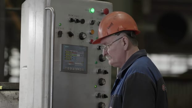 A highly skilled and experienced operator is intently focused on controlling machinery within an industrial environment. Stock Clip
